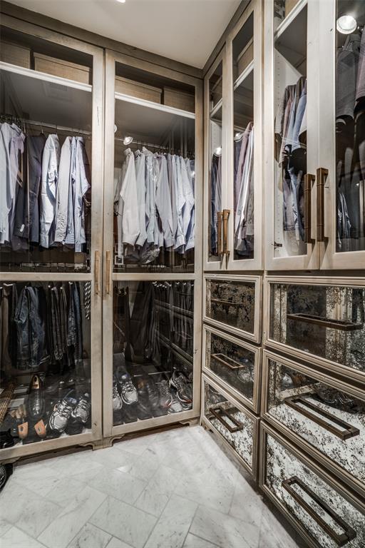 3610 Congress Avenue Dallas, TX 75219 - Photo 24 of 40 a view of walk in closet with clothes and shoes