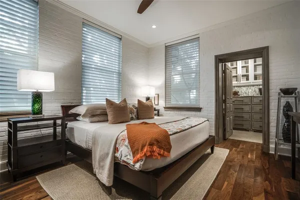 a spacious bedroom with a bed and a lamp