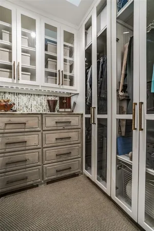 a view of walk in closet with empty racks