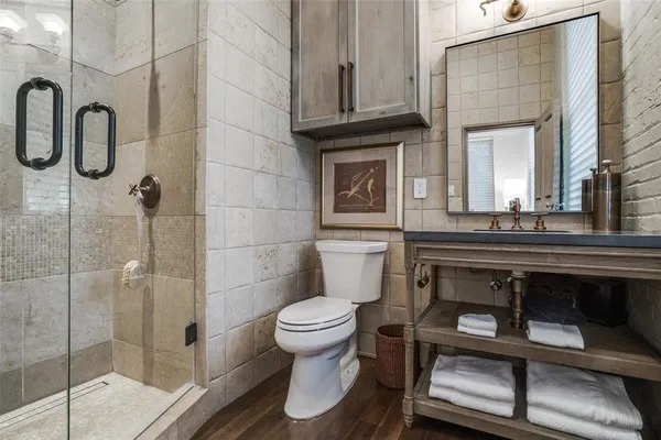 a bathroom with a toilet a sink and mirror