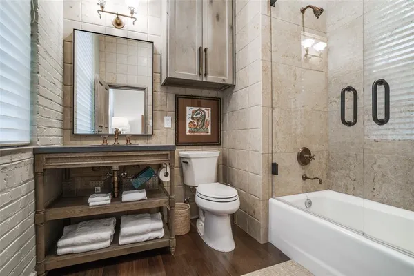 a bathroom with a toilet a sink and bathtub
