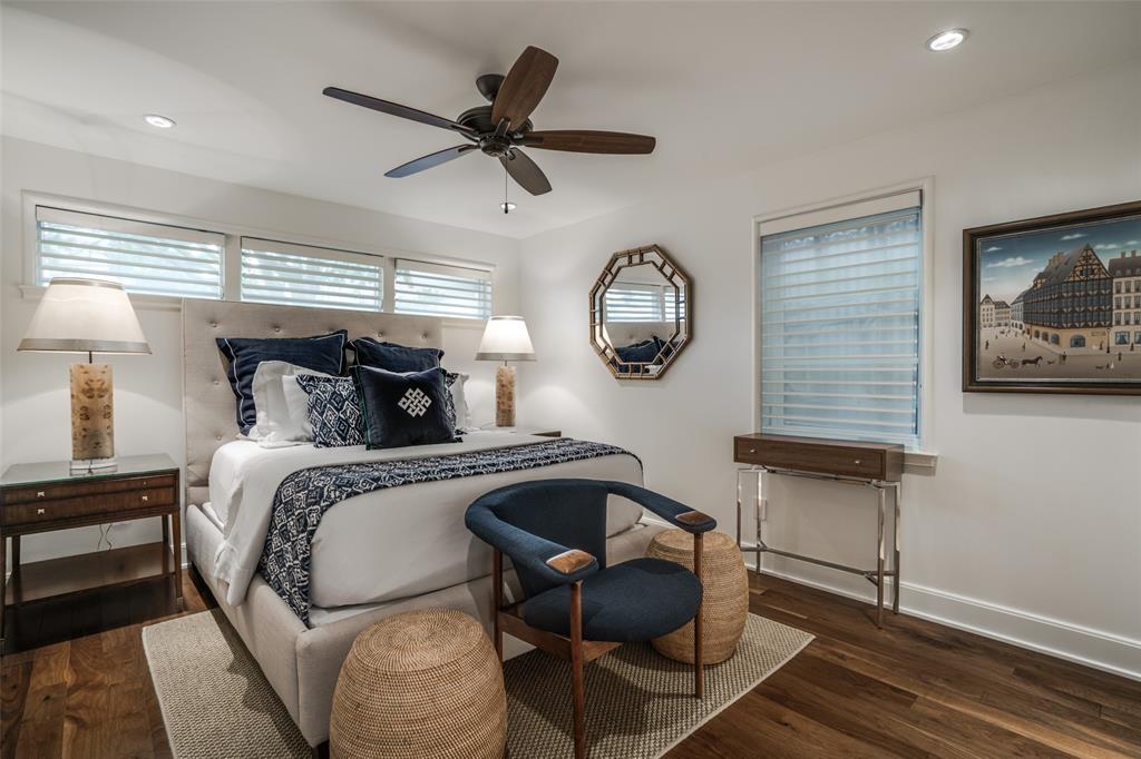 3610 Congress Avenue Dallas, TX 75219 - Photo 32 of 40 a bedroom with a bed and a chandelier