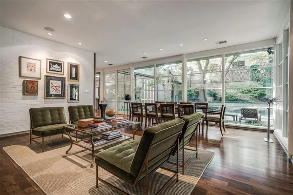 a living room with furniture and a large window with balcony view