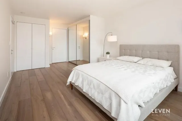 a bedroom with a bed and a chair