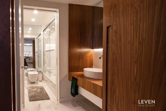 a large bed sitting in a spacious bedroom next to a cabinet