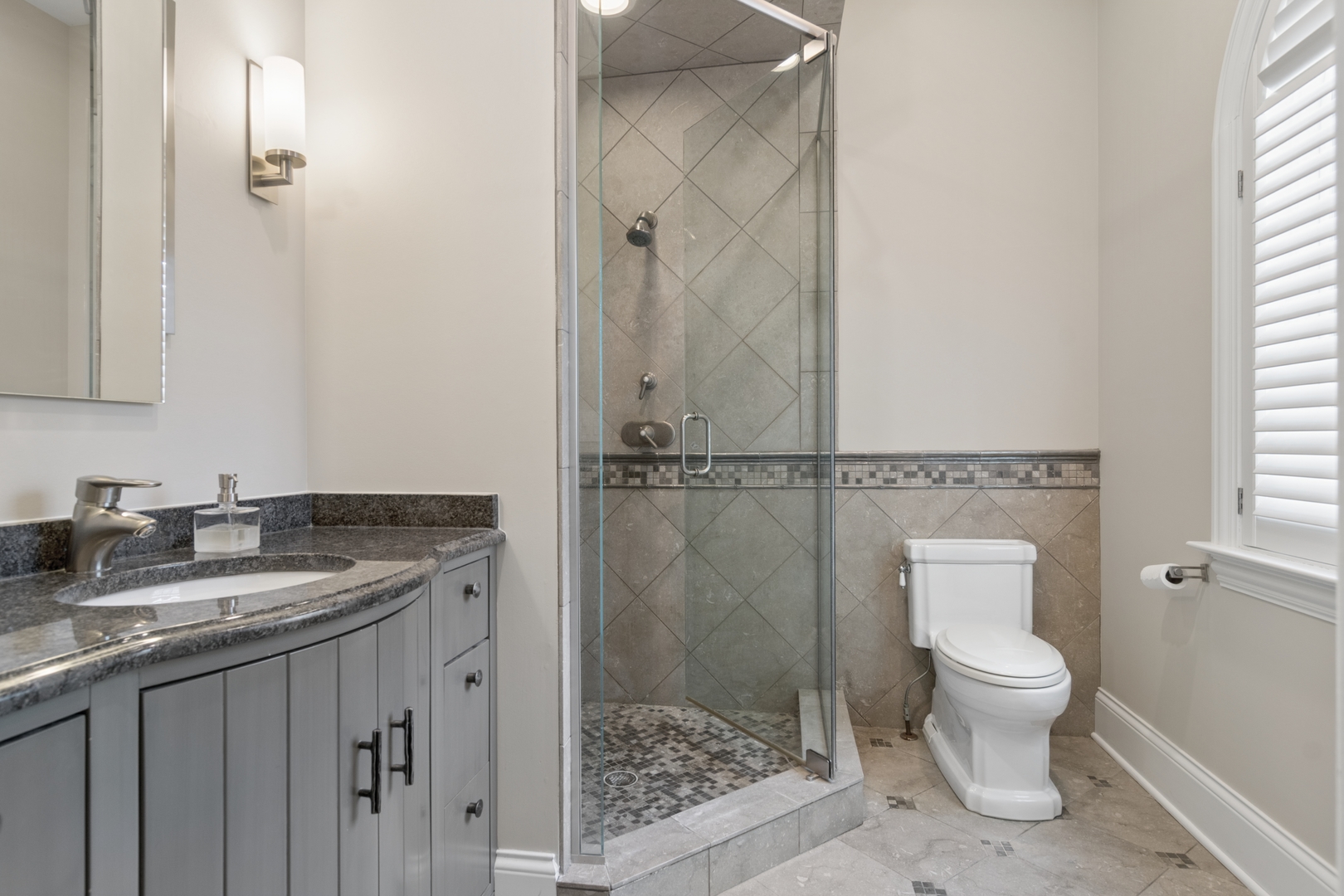 1128 Mt Pleasant Road Winnetka, IL 60093 - Photo 35 of 58 a bathroom with a granite countertop sink a toilet and shower