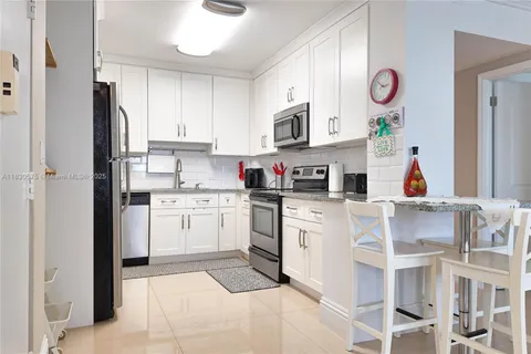 a kitchen with stainless steel appliances granite countertop a sink and cabinets