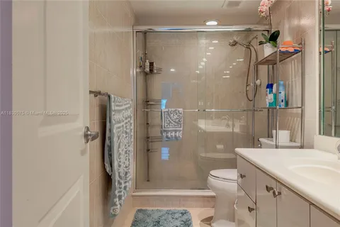 a bathroom with a shower toilet and sink