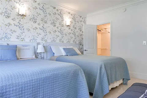 a bedroom with a bed and a wall painting