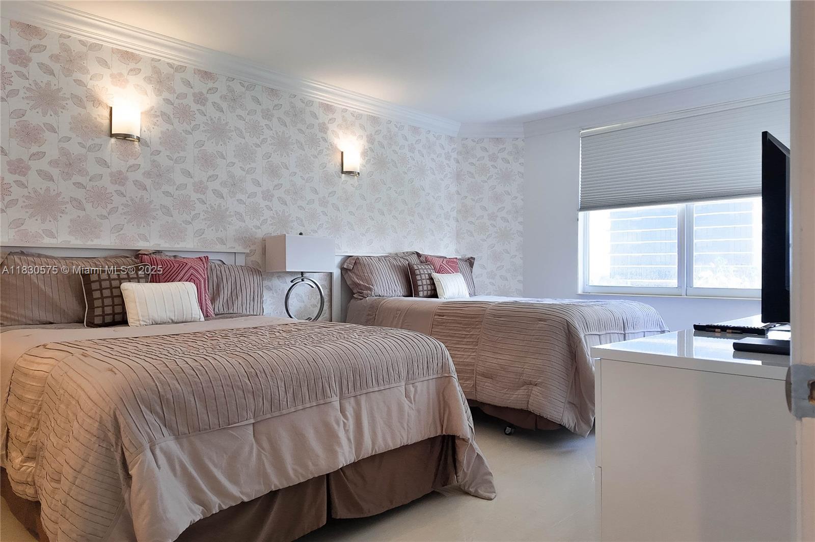 1950 South Ocean Drive, Unit 4E Hallandale Beach, FL 33009 - Photo 23 of 33 a bedroom with two beds and a flat screen tv