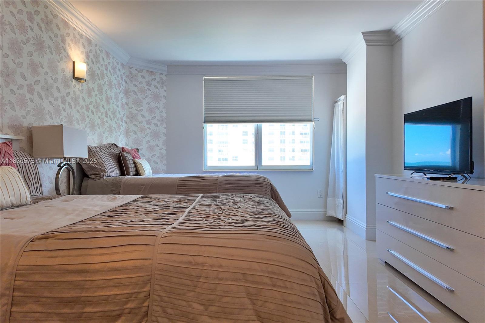 1950 South Ocean Drive, Unit 4E Hallandale Beach, FL 33009 - Photo 26 of 33 a bedroom with a bed and a flat screen tv