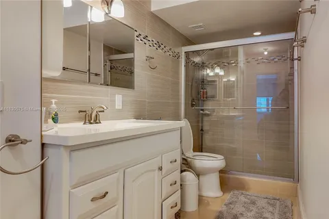 a bathroom with a sink toilet and shower