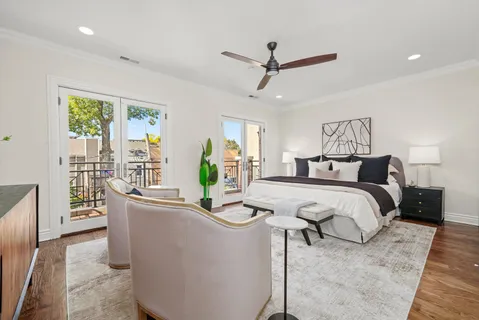 a dining room with furniture and a potted plant