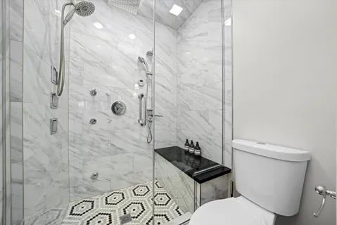 a bed room with a bed and a chair