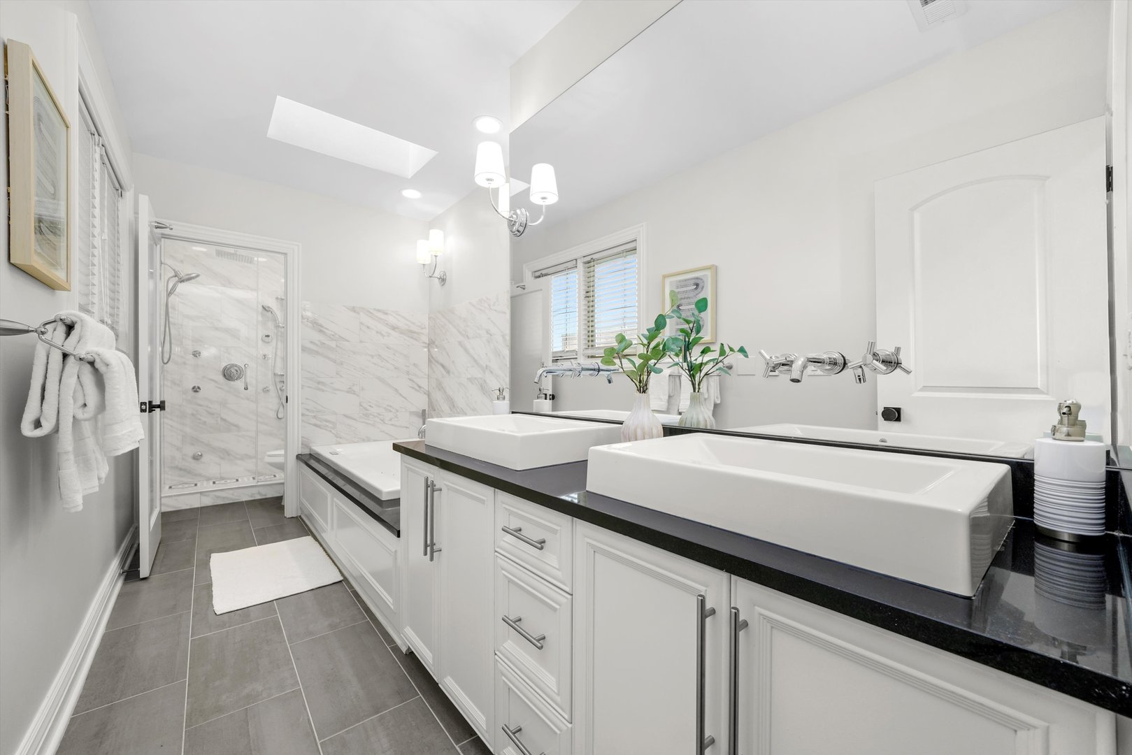 2953 North Honore Street Chicago, IL 60657 - Photo 21 of 40 a spacious bathroom with a double vanity sink mirror and shower
