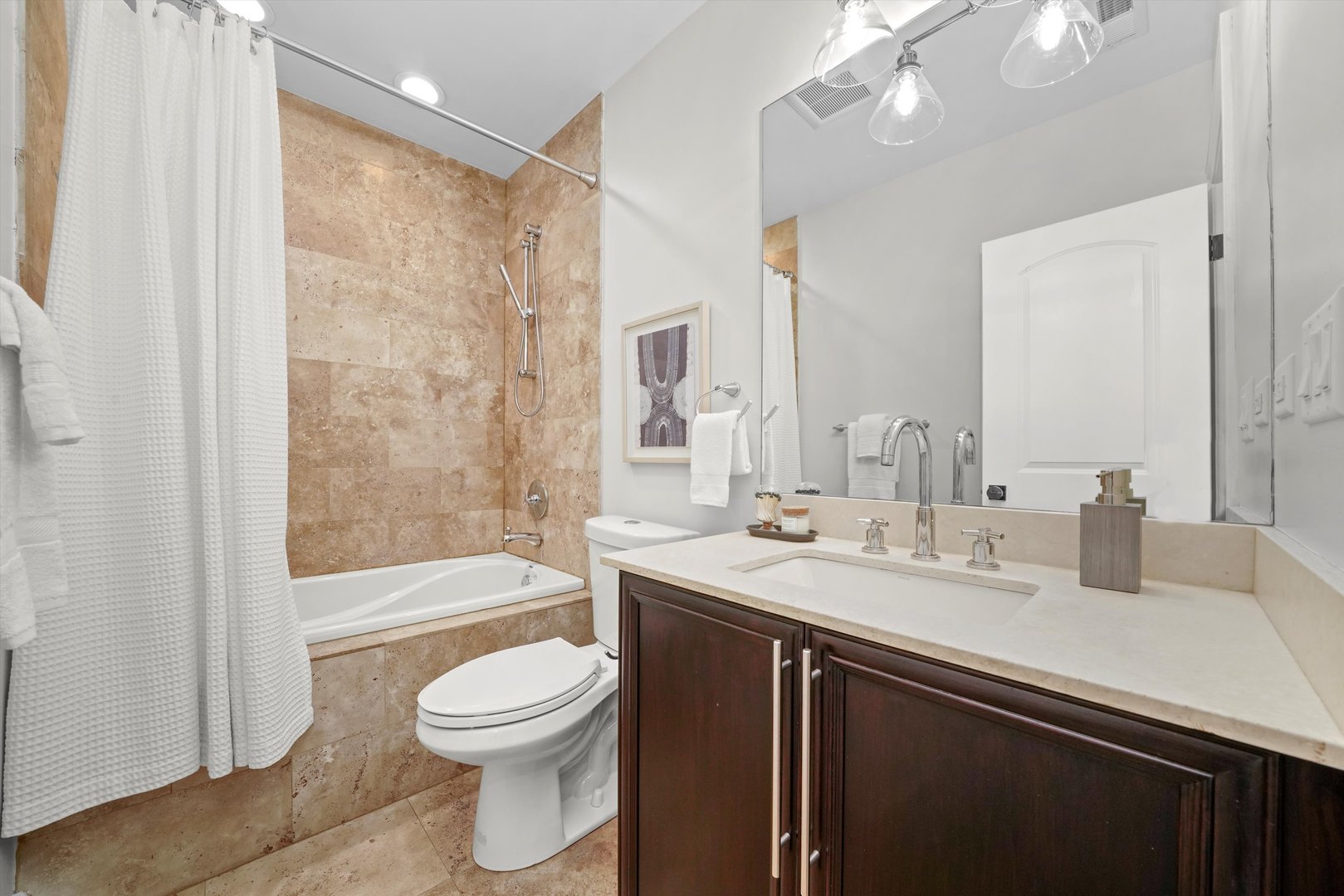 2953 North Honore Street Chicago, IL 60657 - Photo 29 of 40 a bathroom with a granite countertop sink toilet a large mirror a bathtub and shower