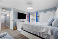833 Riverside Drive, Unit 835 Coral Springs, FL 33071 - Photo 11 of 25 a bedroom with a bed and a flat screen tv