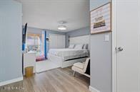 833 Riverside Drive, Unit 835 Coral Springs, FL 33071 - Photo 13 of 25 a bedroom with a bed and a painting on the wall
