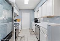 833 Riverside Drive, Unit 835 Coral Springs, FL 33071 - Photo 16 of 25 a kitchen with stainless steel appliances granite countertop a stove a sink and a refrigerator