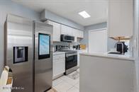 833 Riverside Drive, Unit 835 Coral Springs, FL 33071 - Photo 17 of 25 a kitchen with granite countertop a refrigerator and a sink