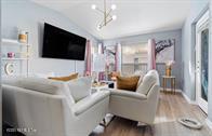 833 Riverside Drive, Unit 835 Coral Springs, FL 33071 - Photo 23 of 25 a living room with furniture and a flat screen tv