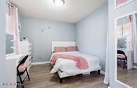 833 Riverside Drive, Unit 835 Coral Springs, FL 33071 - Photo 24 of 25 a bedroom with a bed and a chair