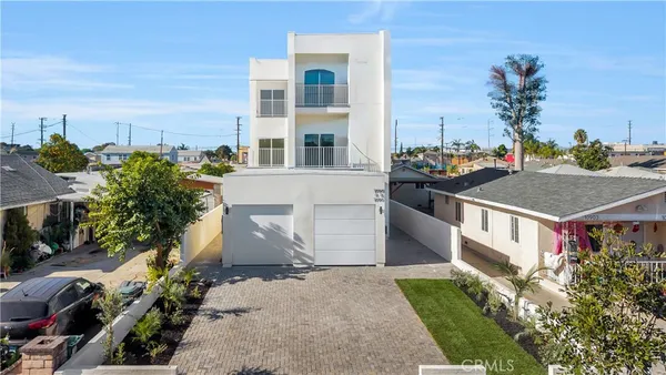 a aerial view of multiple houses with a yard