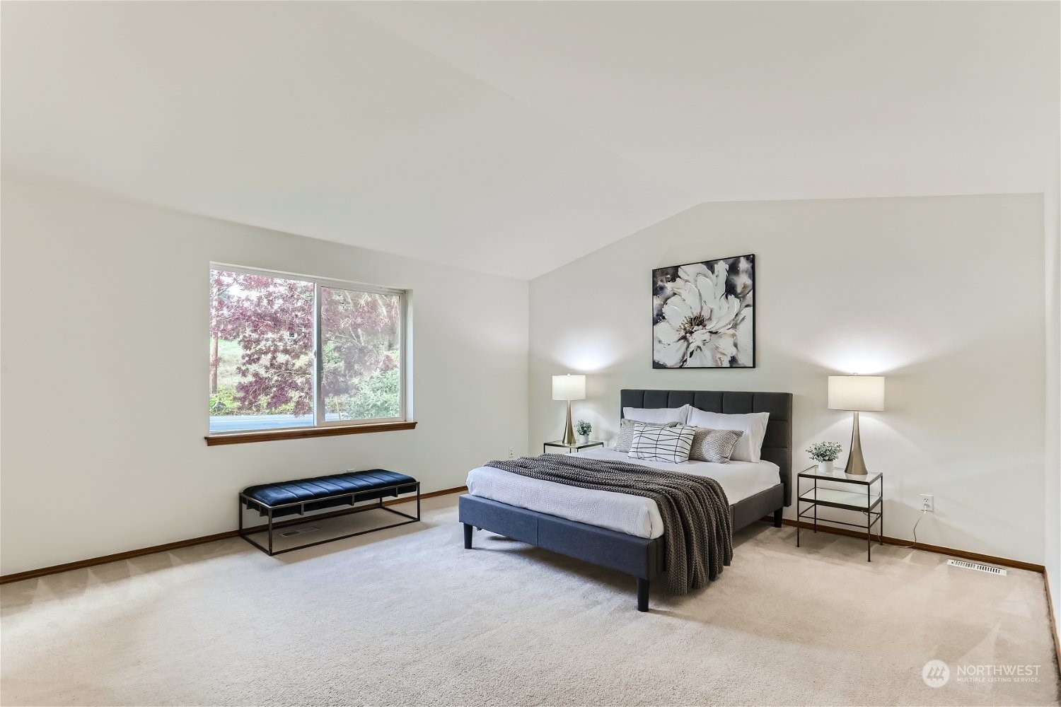 23816 17th Place West Bothell, WA 98021 - Photo 18 of 29 a spacious bedroom with a bed a wall painting and a lamp
