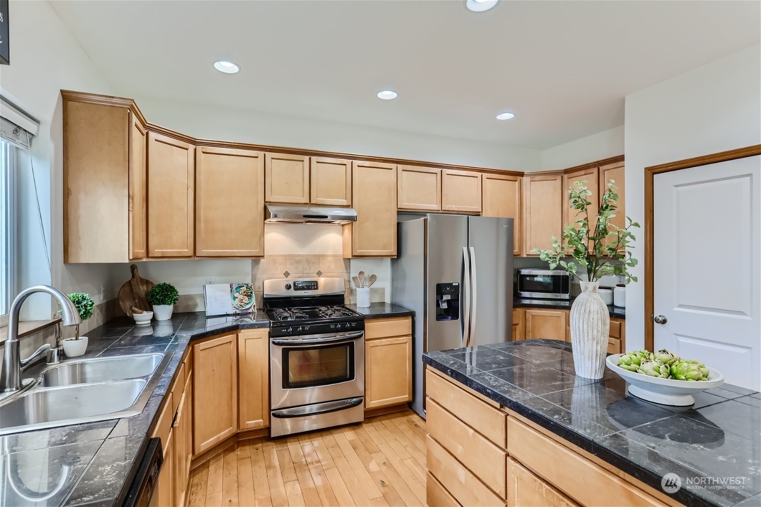 23816 17th Place West Bothell, WA 98021 - Photo 9 of 29 a kitchen with granite countertop a sink appliances and cabinets