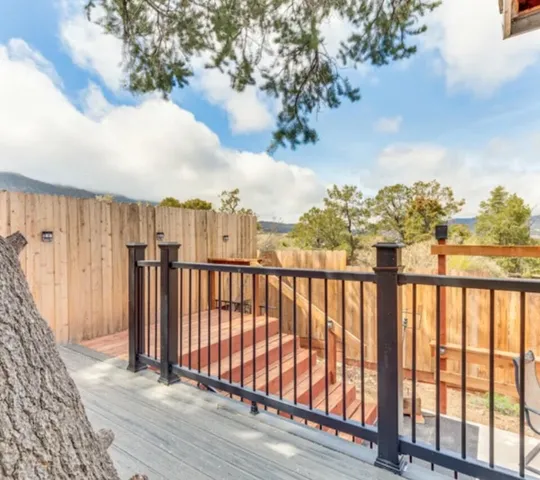 a view of a balcony with wooden fence