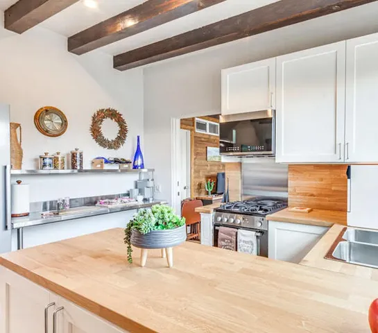 a kitchen with stainless steel appliances granite countertop a sink and a stove