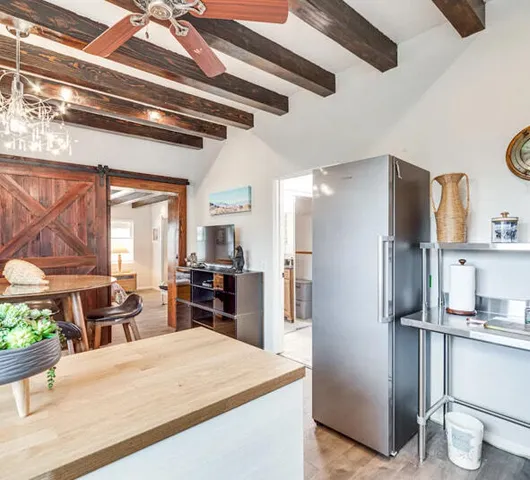 a kitchen with stainless steel appliances kitchen island granite countertop a refrigerator and a stove top oven