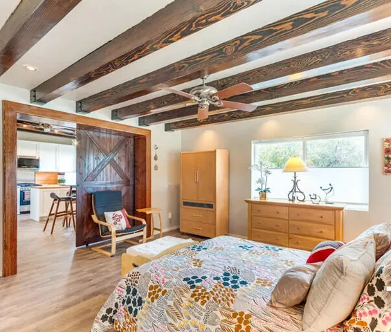 a bedroom with a bed and wooden floor