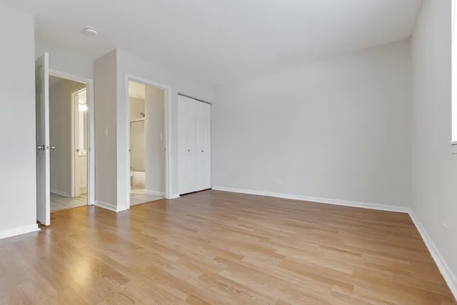 a view of an empty room and wooden floor