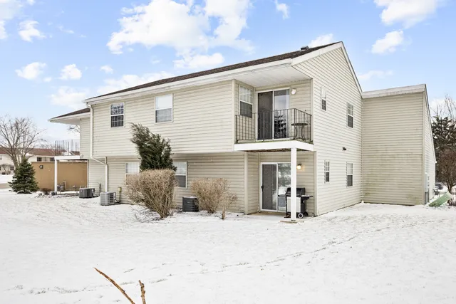 a view of a house with snow on the road