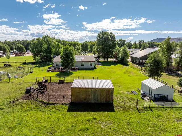 a view of a patio with table and chairs potted plants with wooden floor