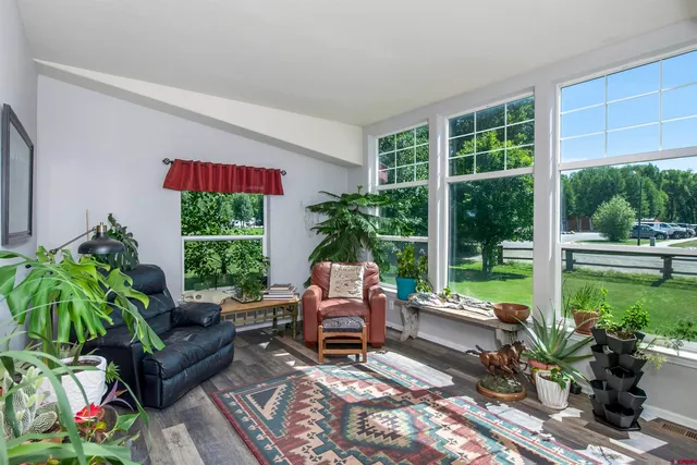 a table and chairs in front of a window