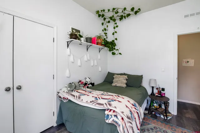 a bedroom with a bed and a window