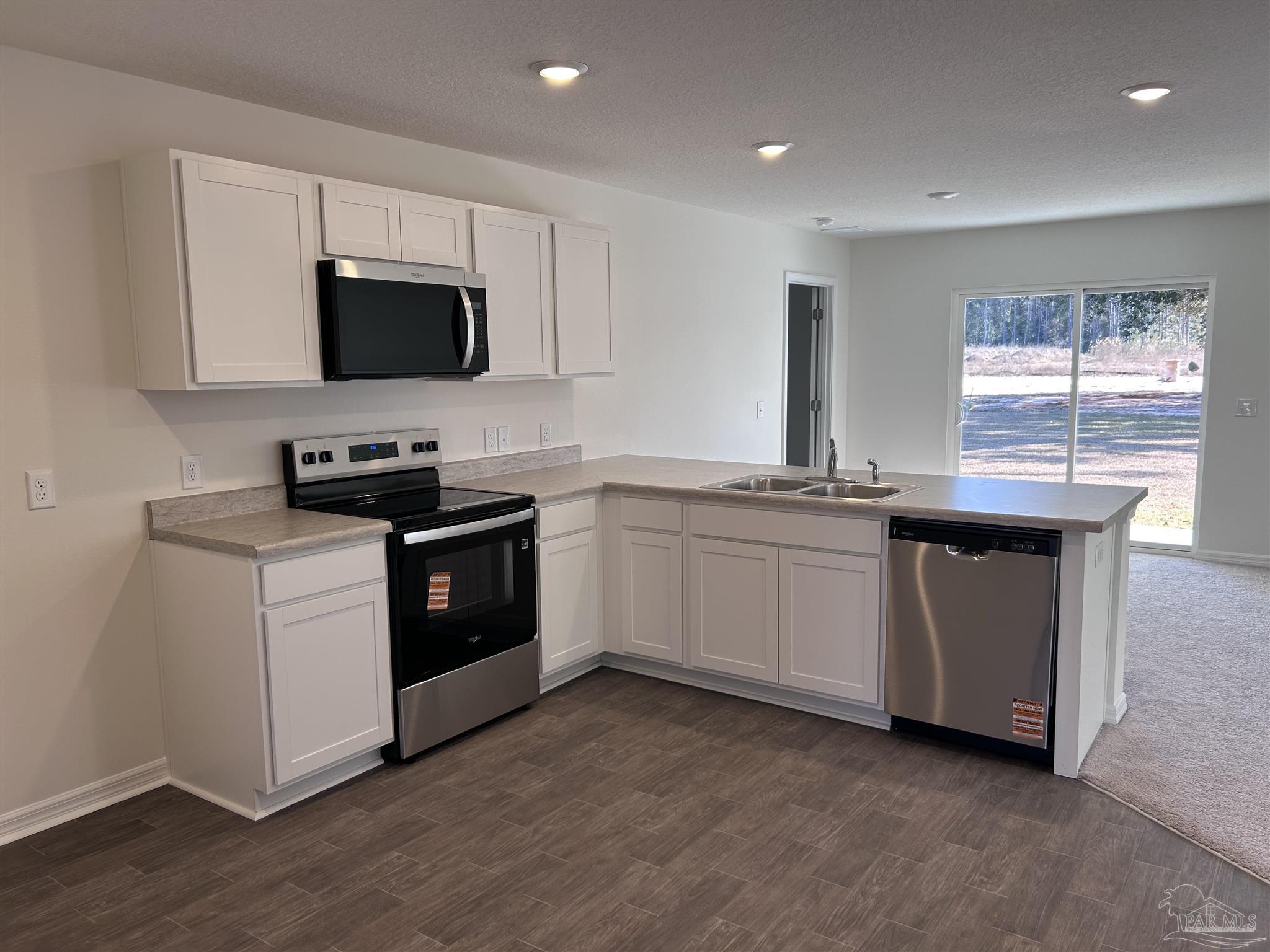 4044 Edgefield Street Pace, FL 32571 - Photo 3 of 4 a kitchen with a sink stove and microwave