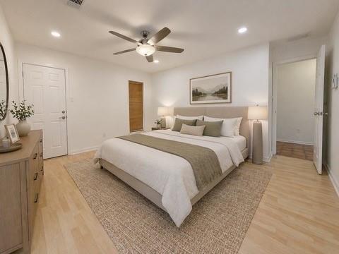5045 Thunder Road Dallas, TX 75244 - Photo 5 of 28 a bedroom with a bed and a chandelier