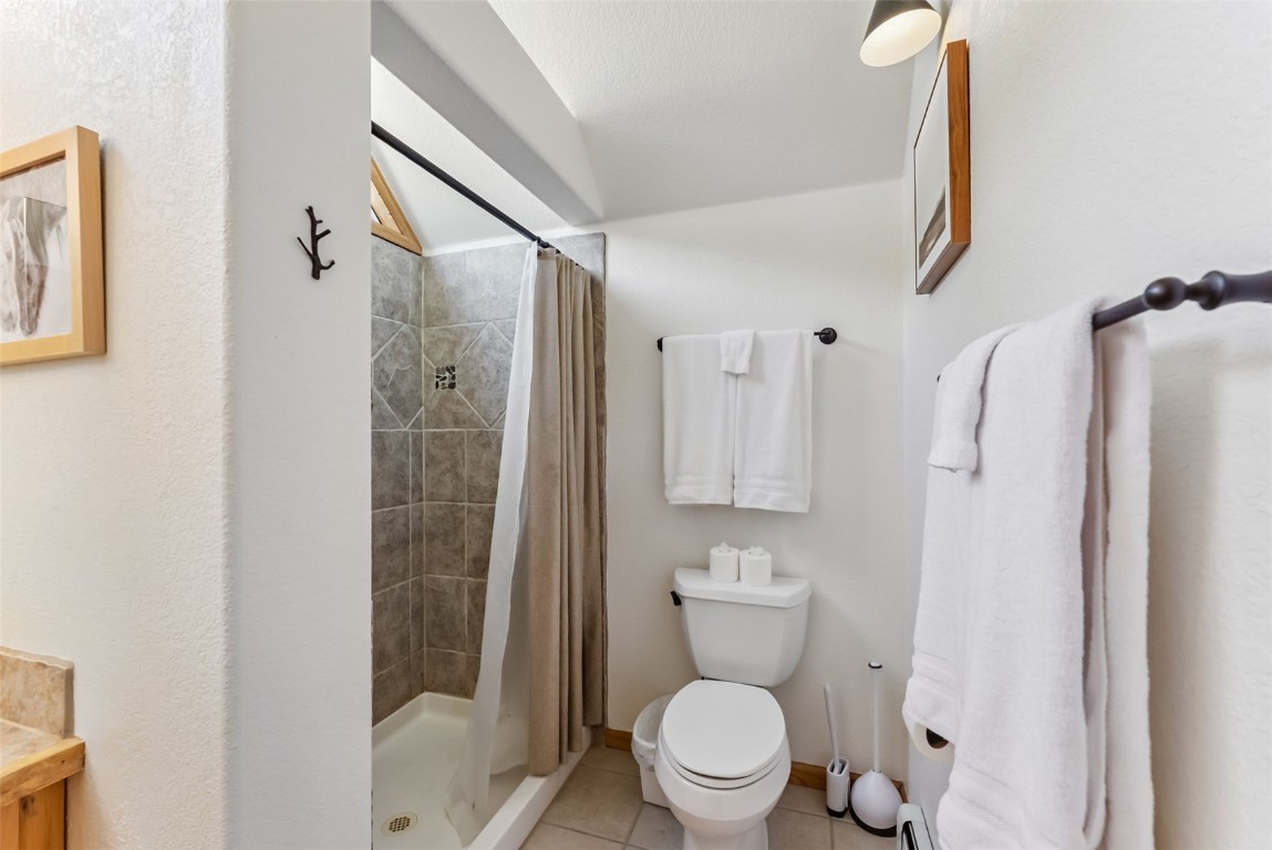 1375 Roberts Road Alma, CO 80420 - Photo 21 of 50 Primary bathroom with tile patterned floors, tiled shower, and vanity