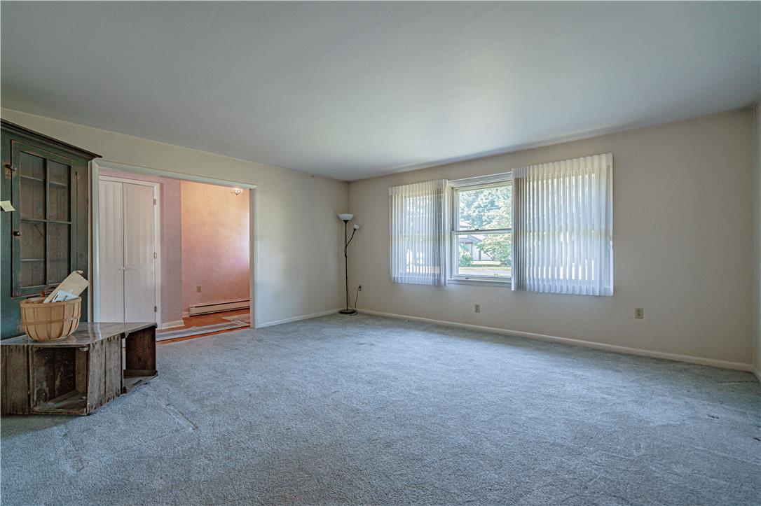 4815 Mill Road Schnecksville, PA 18078 - Photo 10 of 48 A well-lit living area awaits, offering a comfortable space with a seamless flow to an adjacent room.