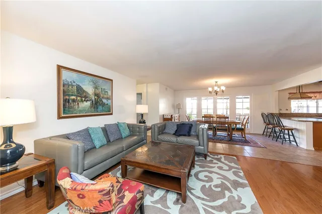a living room with furniture wooden floor and a lamp