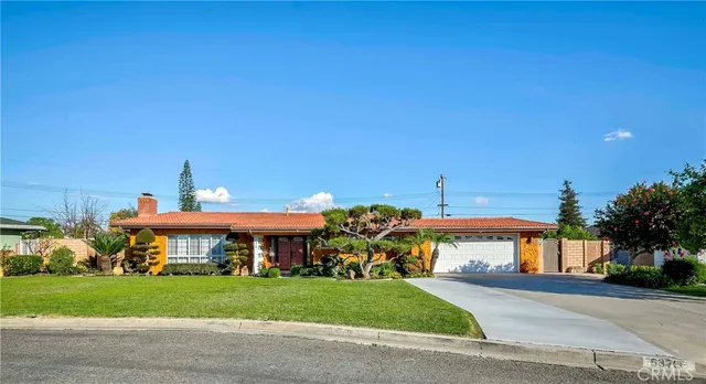 a front view of a house with a yard and a garage