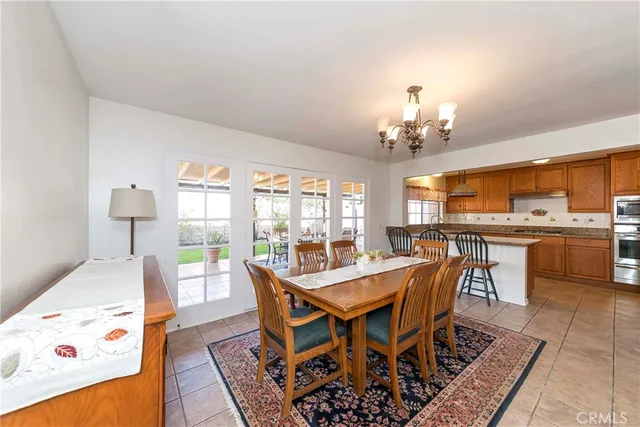 a view of a dining room with furniture and a chandelier