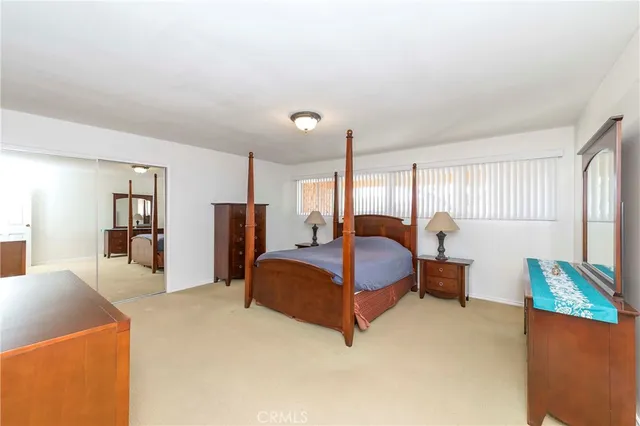 a bedroom with bed and window