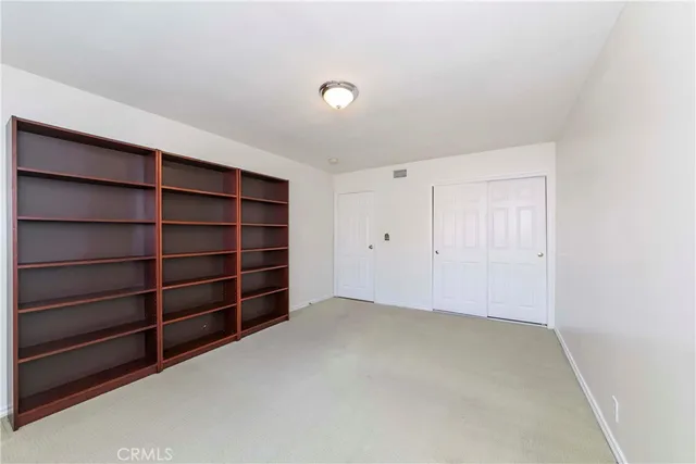 a view of an empty room with empty shelves