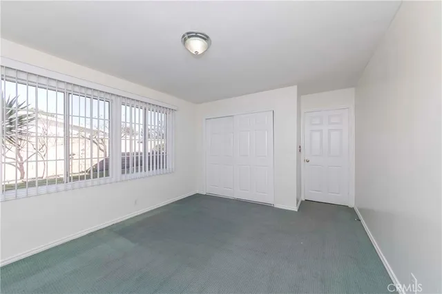 an empty room with a empty space and windows