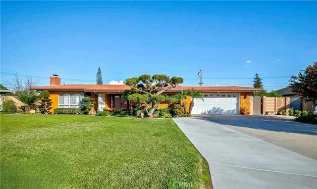 a view of a house with a yard and a patio