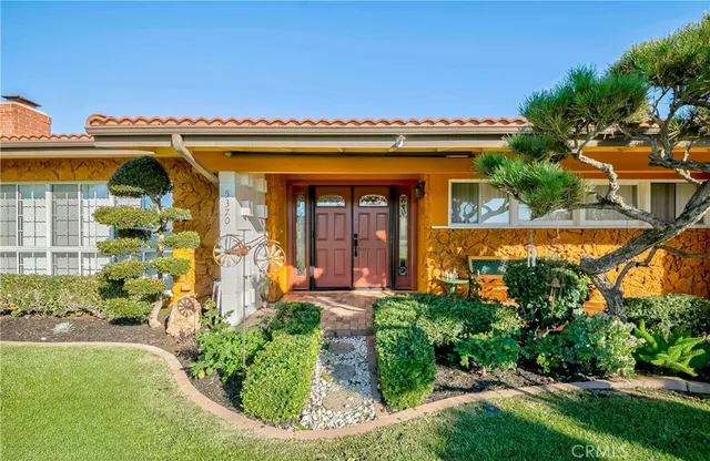 front view of a house with a garden